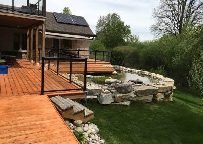 Large above-ground koi pond built by A Touch of Dutch Landscaping