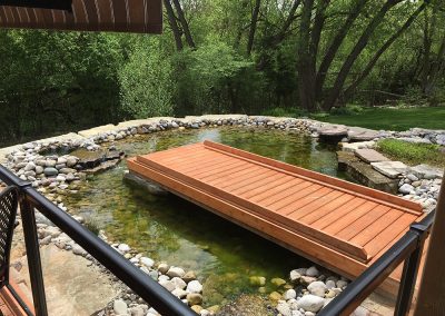 Large above-ground koi pond built by A Touch of Dutch Landscaping