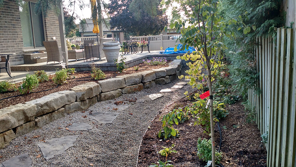 Hardscaping - walkway with stepping stones and armour stone retaining wall