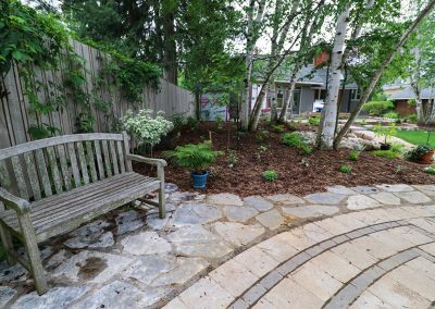 Sitting area beside Stone Labyrinth by A Touch of Dutch Landscaping
