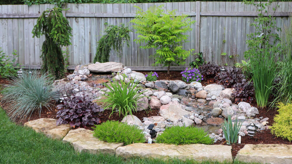 Pondless waterfall, natural stone and garden Installation