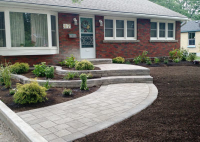 curb appeal raised flower beds gardens natural stone curved walkway pavers retaining walls perennials shrubs