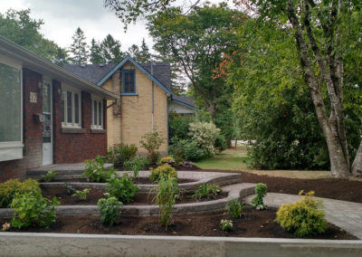 raised flower beds gardens natural stone curved walkway pavers retaining walls perennials shrubs