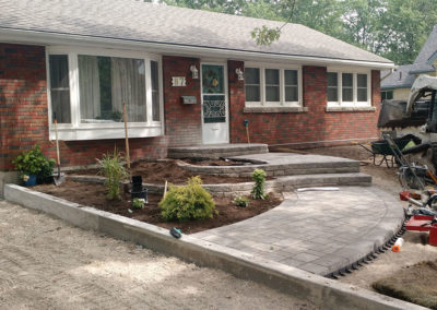 curb appeal raised flower beds gardens natural stone curved walkway pavers retaining walls perennials shrubs