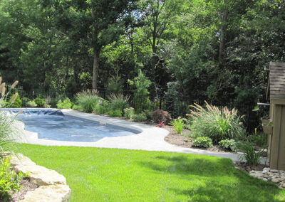 Backyard Oasis ornamental grasses perennials pool natural armour stone