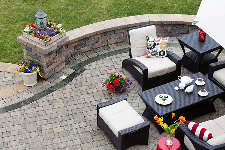 choosing patio materials stone pavers interlocking brick retaining wall boarder neutral beige traditional