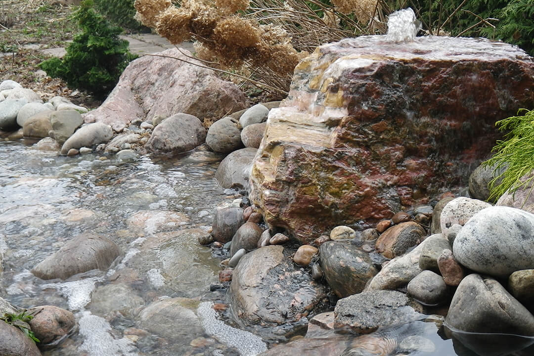 bubbling rocks water feature backyard oasis gurgling sound