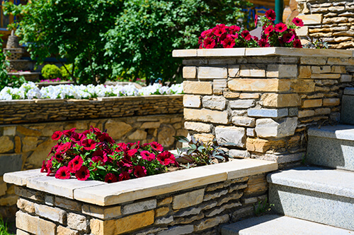Multifunctional landscaping elements retaining wall with raised flowerbeds