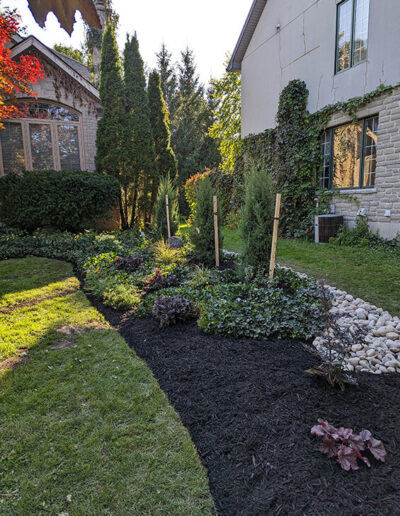 Flowerbed Redesign adds a sleek modern focal point to a beautiful home.