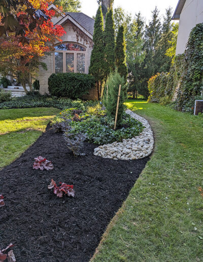 Flowerbed Redesign adds a sleek modern focal point to a beautiful home.